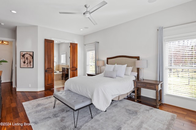 bedroom with dark hardwood / wood-style floors, ceiling fan, and connected bathroom