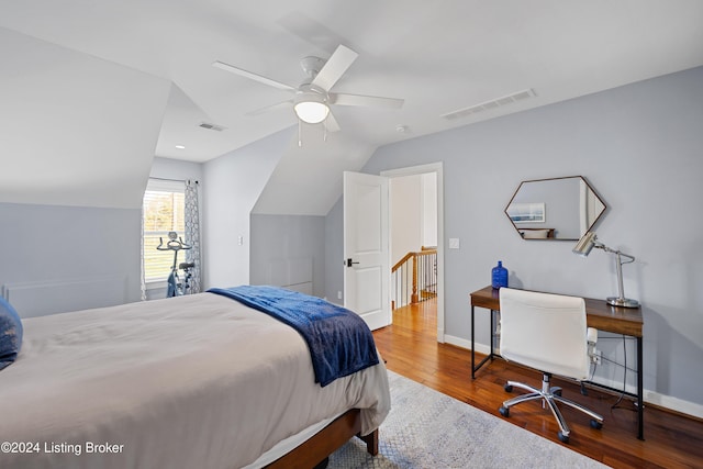 bedroom featuring ceiling fan, lofted ceiling, and hardwood / wood-style flooring