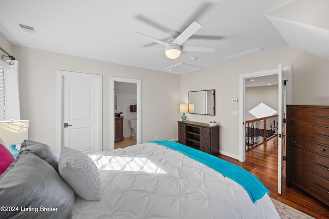 bedroom featuring ceiling fan, ensuite bathroom, and dark wood-type flooring