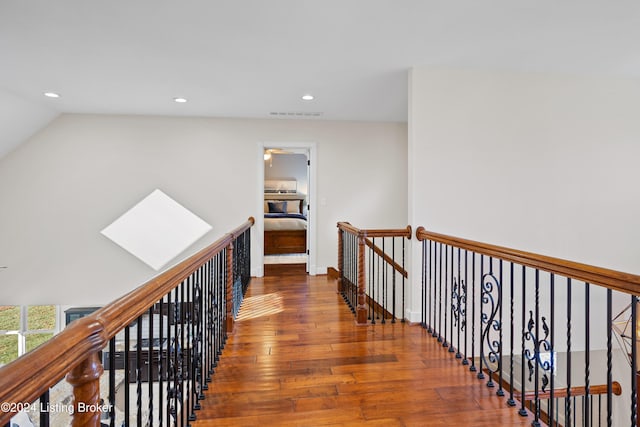 hallway featuring hardwood / wood-style floors and lofted ceiling