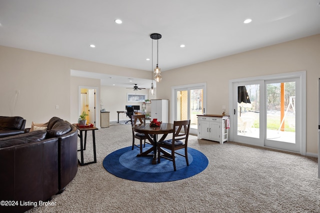 dining area with ceiling fan, plenty of natural light, and carpet floors