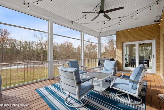 sunroom with a wealth of natural light and ceiling fan