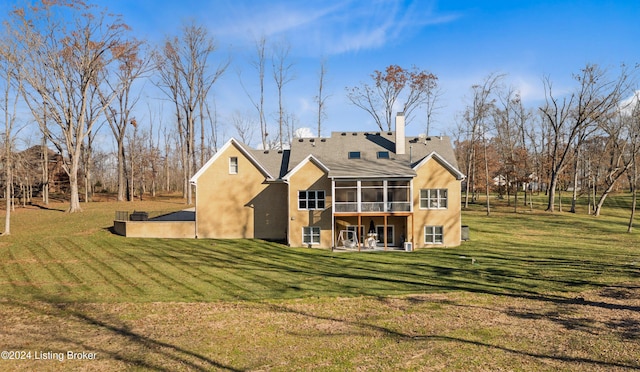 back of house with a lawn and a sunroom