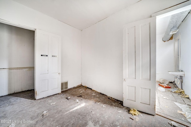 unfurnished bedroom featuring visible vents