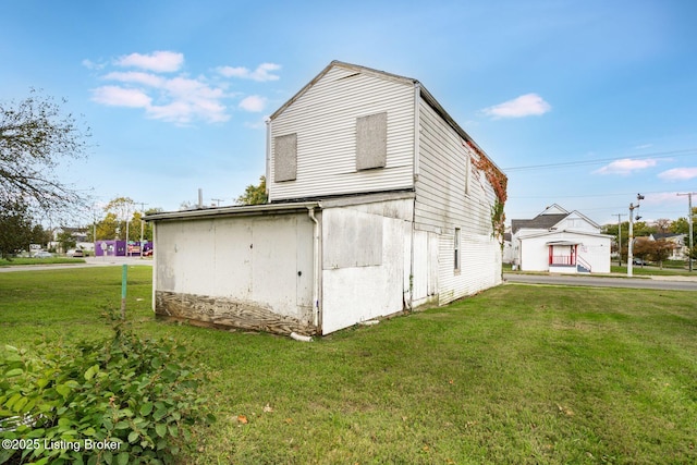 view of property exterior featuring a barn, a lawn, and an outdoor structure