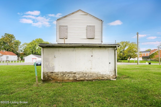 back of property featuring a lawn