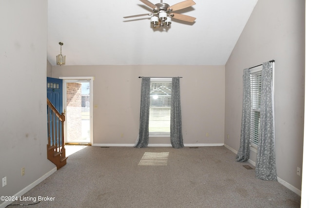 carpeted spare room with high vaulted ceiling, plenty of natural light, and ceiling fan