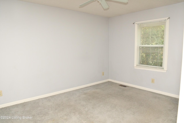 unfurnished room featuring ceiling fan and light colored carpet