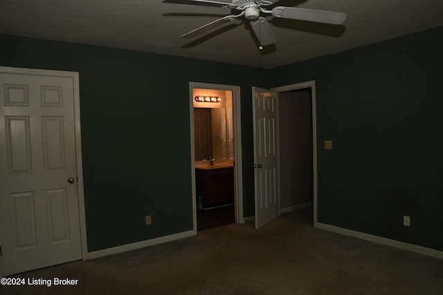 unfurnished bedroom featuring carpet flooring, ceiling fan, sink, and ensuite bathroom