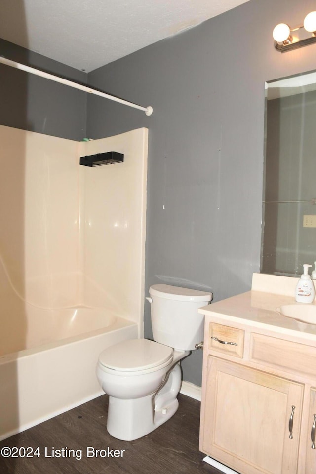 full bathroom featuring hardwood / wood-style floors, vanity, toilet, and shower / bathtub combination