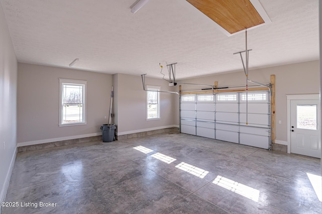 garage with a garage door opener and baseboards