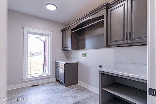 laundry area featuring visible vents, a healthy amount of sunlight, hookup for a washing machine, cabinet space, and hookup for an electric dryer