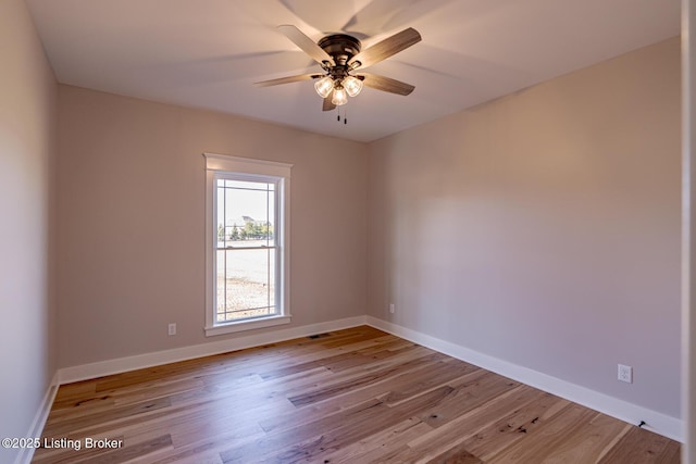 unfurnished room with visible vents, ceiling fan, baseboards, and wood finished floors