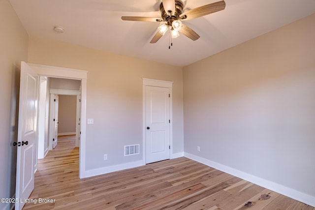 unfurnished bedroom featuring visible vents, a ceiling fan, light wood-type flooring, and baseboards