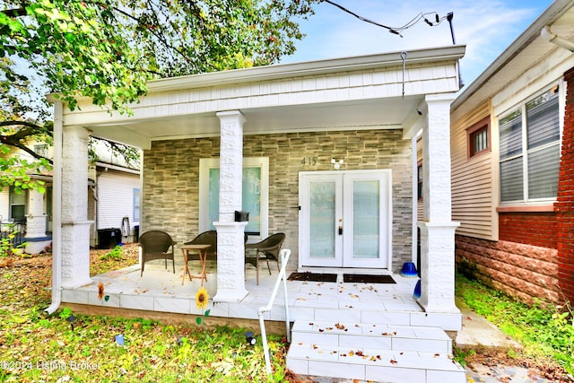 exterior space with a porch and french doors