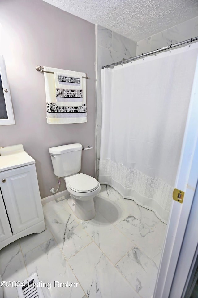 bathroom featuring a shower with curtain, vanity, a textured ceiling, and toilet