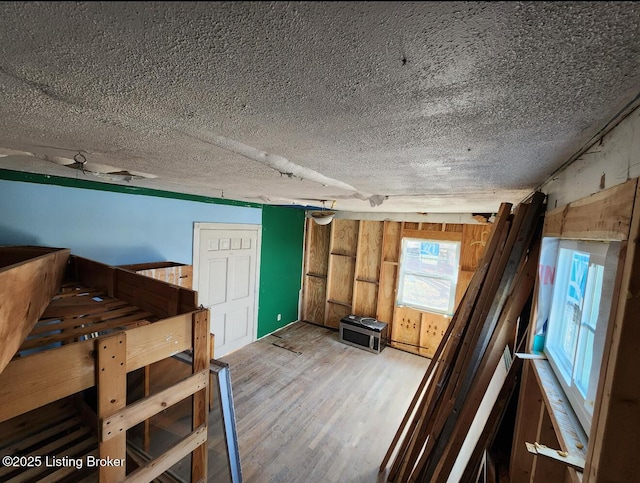 miscellaneous room with wood-type flooring and a textured ceiling