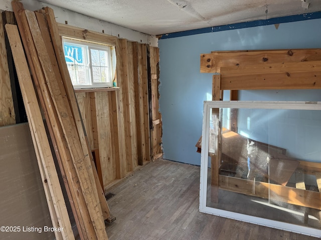 unfurnished bedroom with hardwood / wood-style floors and a textured ceiling