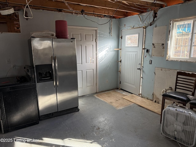 kitchen featuring concrete flooring, stainless steel refrigerator with ice dispenser, and range