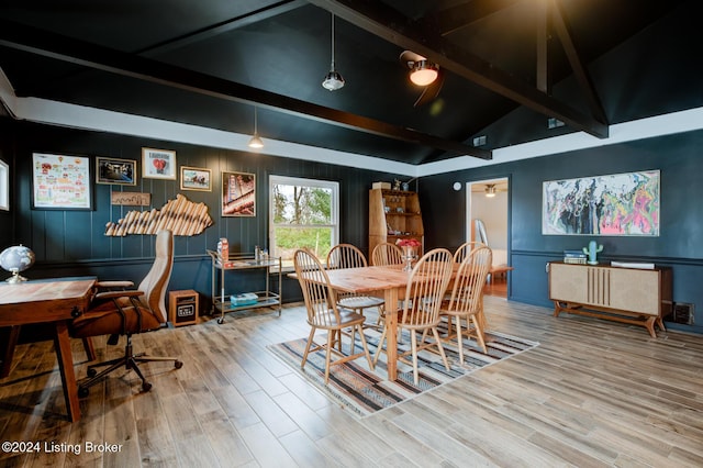 dining area featuring vaulted ceiling with beams and hardwood / wood-style floors