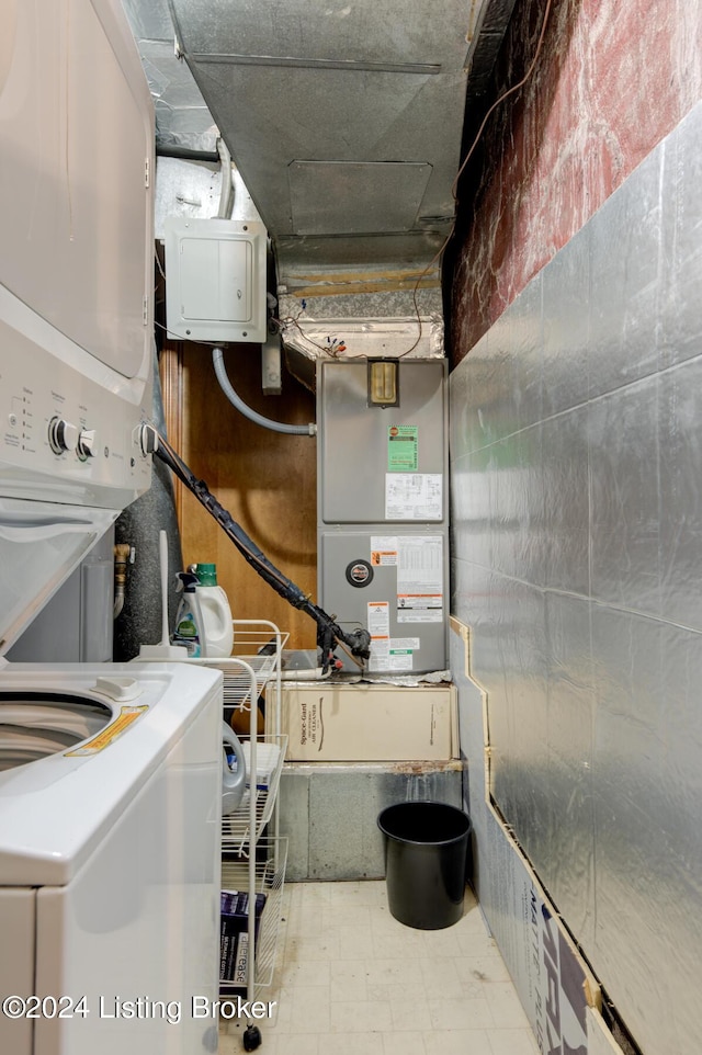 clothes washing area with stacked washer and dryer