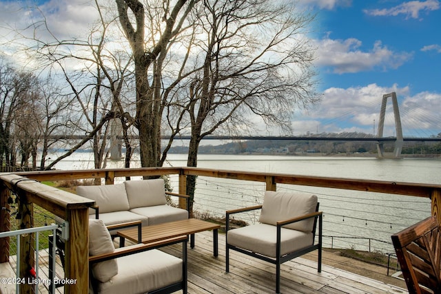 wooden terrace featuring outdoor lounge area and a water view