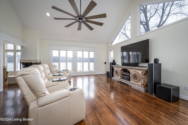 living room with a water view, ceiling fan, high vaulted ceiling, and dark hardwood / wood-style floors