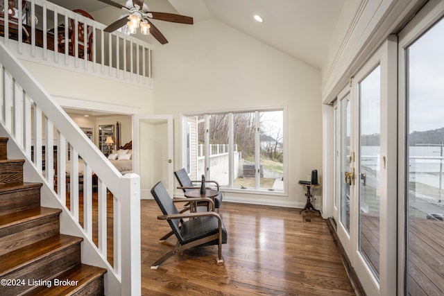 stairs featuring ceiling fan, high vaulted ceiling, and wood-type flooring