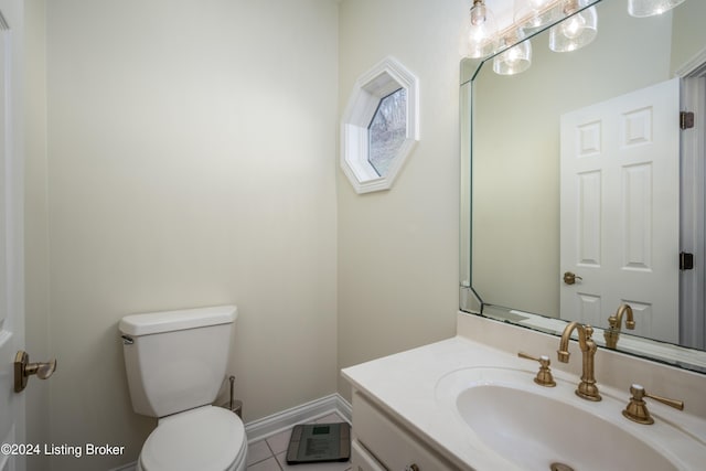 bathroom with tile patterned flooring, vanity, and toilet