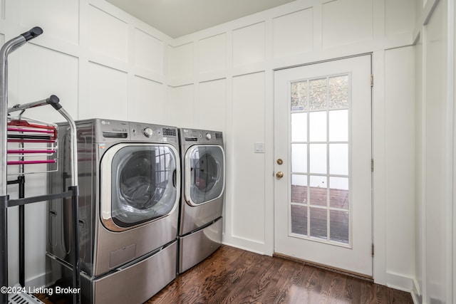 laundry room with separate washer and dryer and dark wood-type flooring