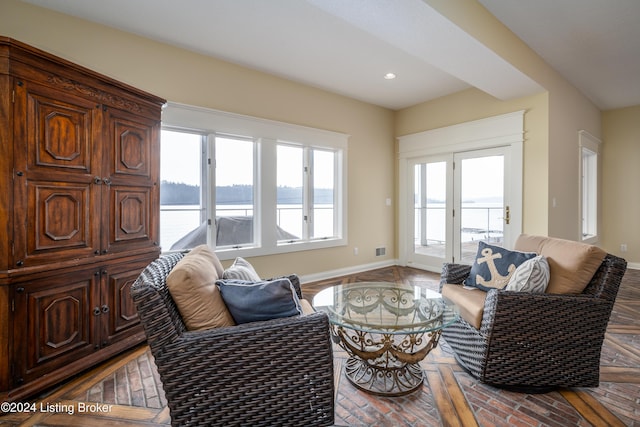 living room with a water view and a healthy amount of sunlight