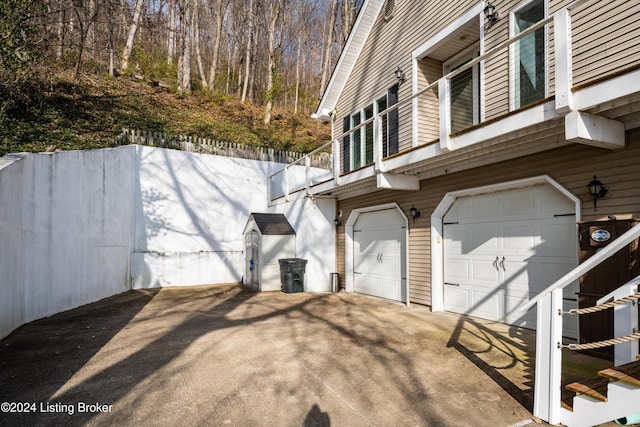 view of home's exterior with a balcony and a garage