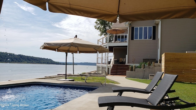 view of swimming pool with a water view