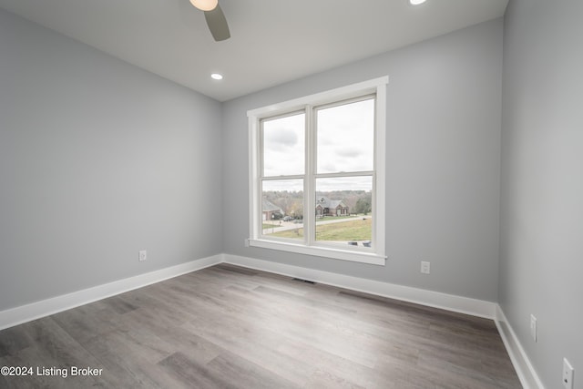 unfurnished room featuring hardwood / wood-style floors and ceiling fan