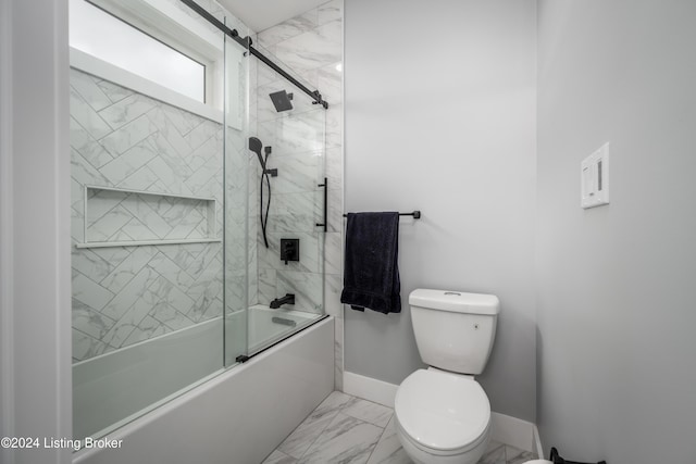 bathroom featuring toilet and combined bath / shower with glass door