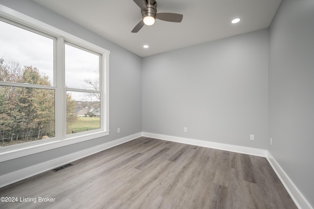 spare room with ceiling fan and hardwood / wood-style flooring