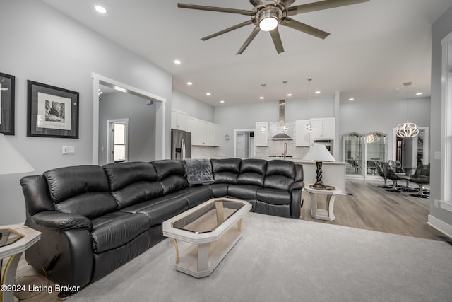 living room with ceiling fan and light wood-type flooring