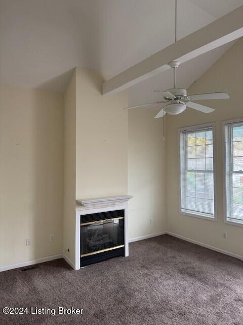 unfurnished living room with dark colored carpet, ceiling fan, and lofted ceiling