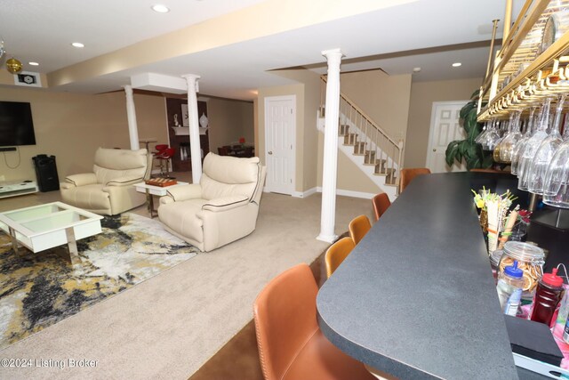 living room with carpet flooring and decorative columns