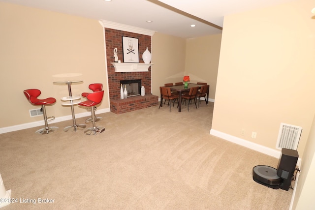 living area featuring light carpet and a fireplace