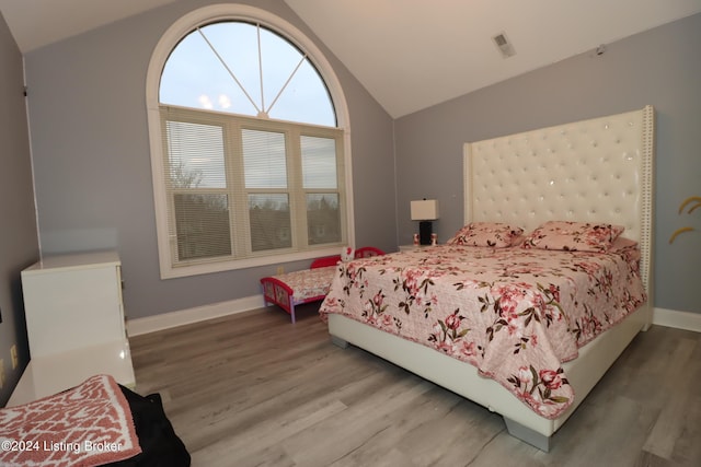 bedroom featuring lofted ceiling and hardwood / wood-style flooring