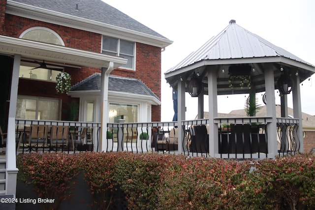 rear view of property featuring a gazebo