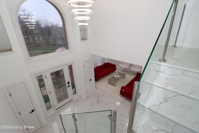 interior space with a notable chandelier and a high ceiling