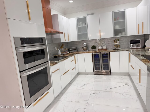 kitchen featuring white cabinetry, stainless steel double oven, beverage cooler, dark stone countertops, and black electric cooktop