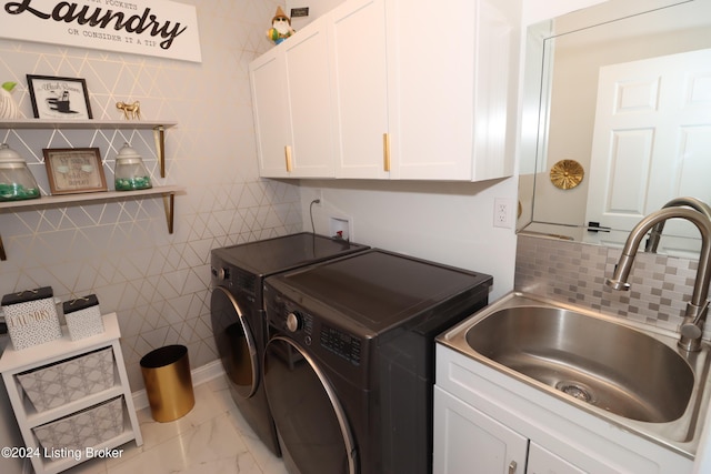 washroom with separate washer and dryer, sink, cabinets, and tile walls