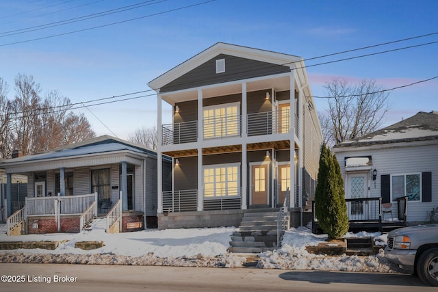 view of property featuring covered porch and a balcony