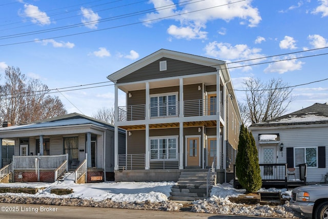 front facade featuring a balcony and a porch