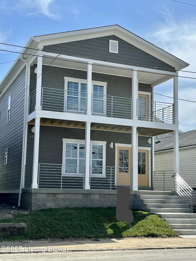 view of front of property featuring covered porch and a balcony