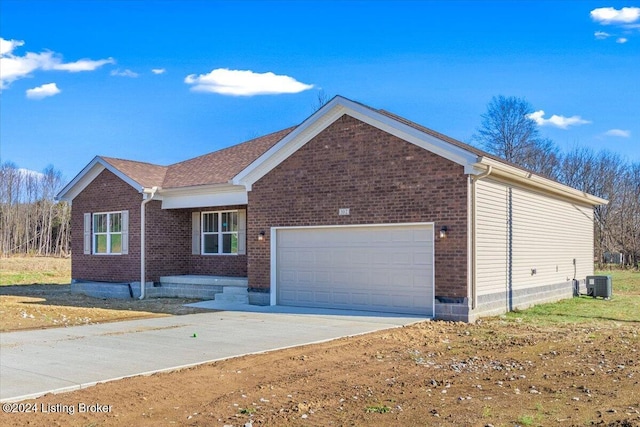 view of front facade featuring central AC and a garage