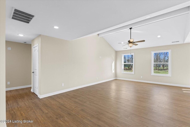 empty room featuring wood-type flooring, lofted ceiling with beams, and ceiling fan